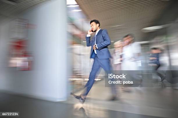 Mixed Race Businessman In Busy Workplace Stock Photo - Download Image Now - Blurred Motion, Office, Motion