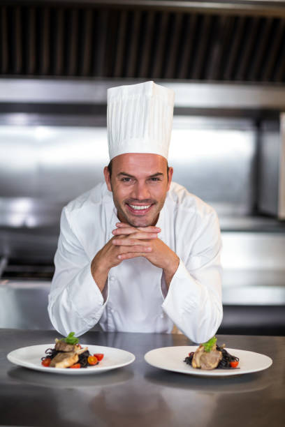 istock Portrait of smiling chef standing in kitchen 667227104