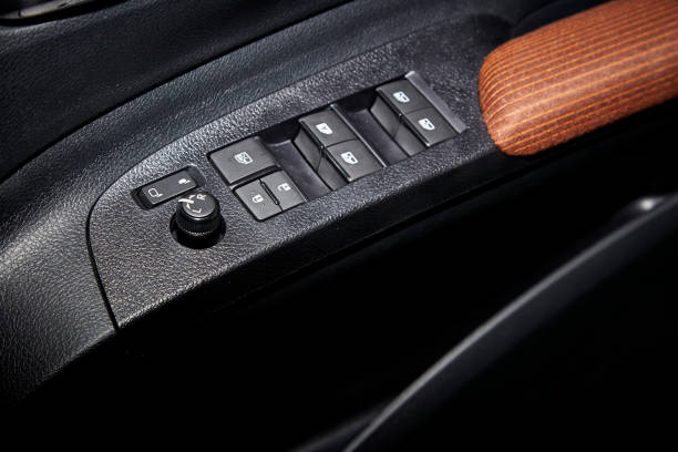 istock Car interior details of door handle with windows controls and adjustments. 667227310