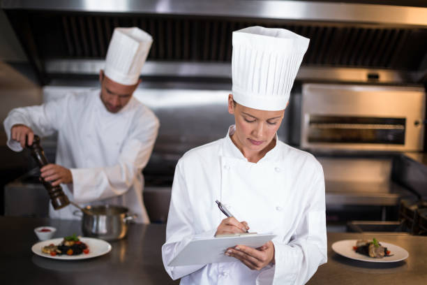 istock Female chef writing on clipboard 667229510