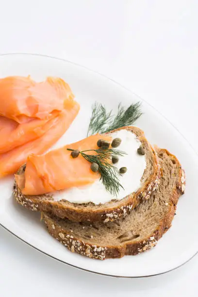 Photo of sandwich with cheese cream and smoked salmon garnished with fennel