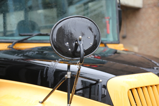 Wet black mirrir school yellow black vehicle