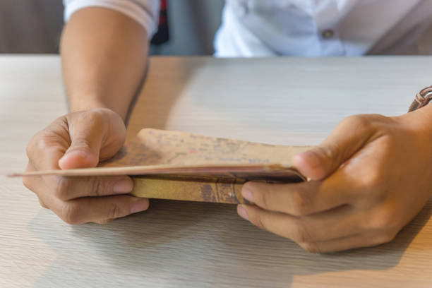 istock Closeup of males hand reading information in notebook 667242602