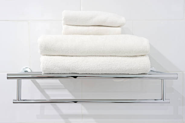 istock white bath towels on towel rack 667244900