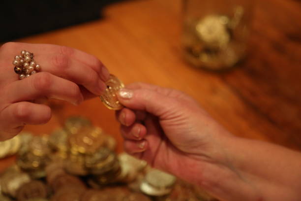 istock Two females hands holdin coin 667247758