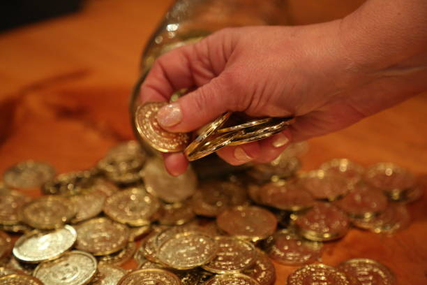 istock Elderly woman hand holding coin 667247788