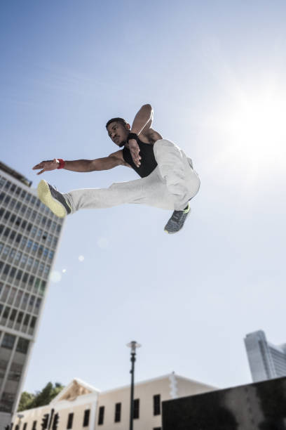 istock Extreme athlete jumping in front of building 667248084