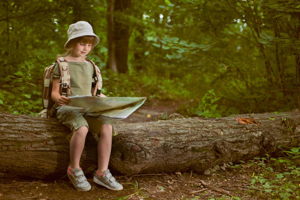 young girl scout, explores  nature on camping trip
