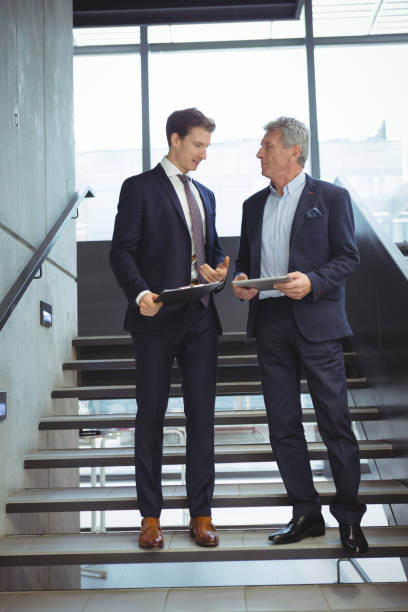 istock Business executives having a conversation on stairs 667251388