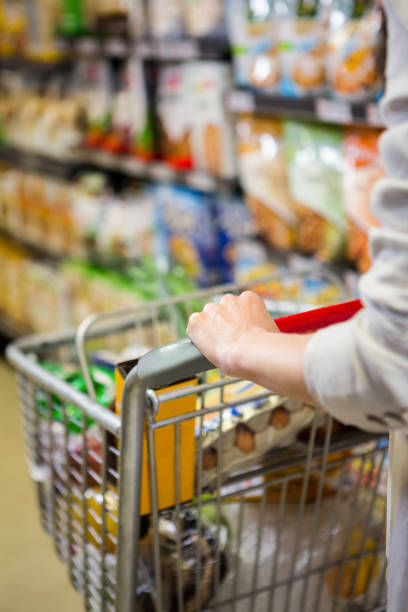 istock Cropped image of woman pushing trolley 667251406
