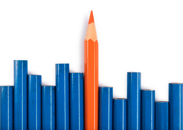 istock Orange pencil isolated on white standing out from the crowd 667256312