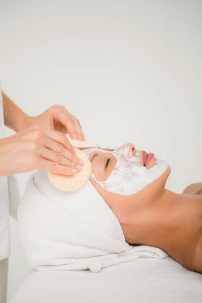 istock Hand cleaning womans face with cotton swabs 667262622