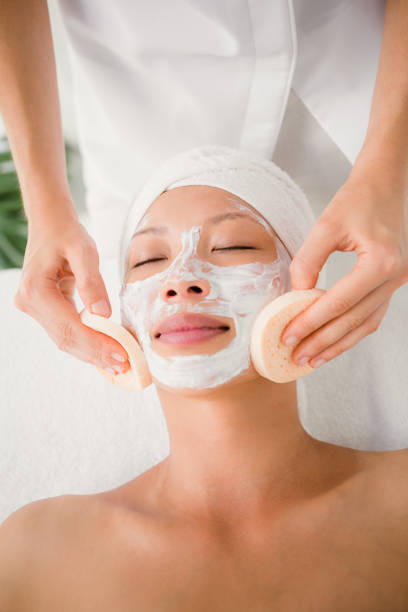 istock Hand cleaning womans face with cotton swabs 667262770