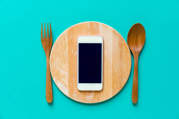 istock mobile phone served on wood plate, concept and idea 667264198
