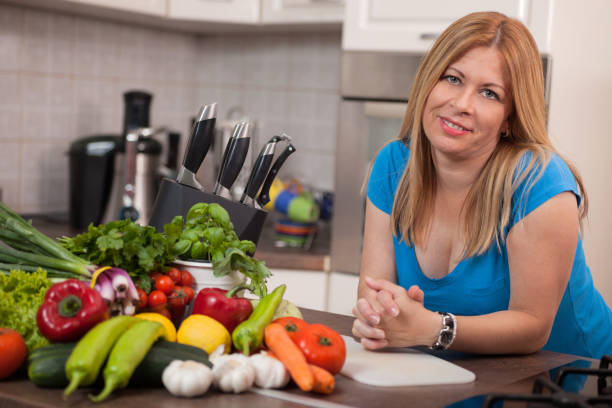 istock Pregnant woman preparing in the kitchen posing 667267986