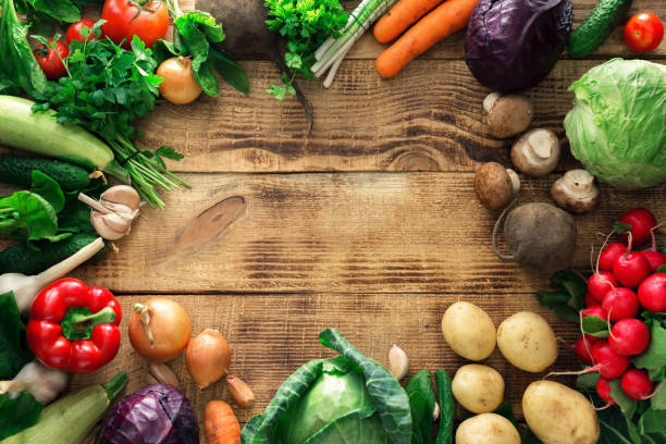 istock Frame of different vegetables on a wooden table 667271258