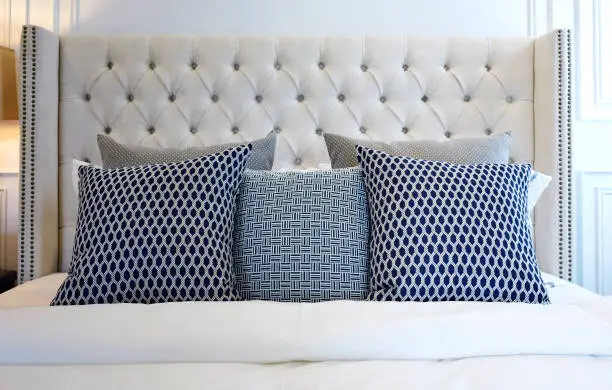 pillows on modern black and white bed in bedroom at home.