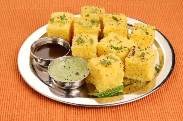 Indian Vegetarian Food Dhokla /Gujrati khaman Dhokla  isolated over green mat