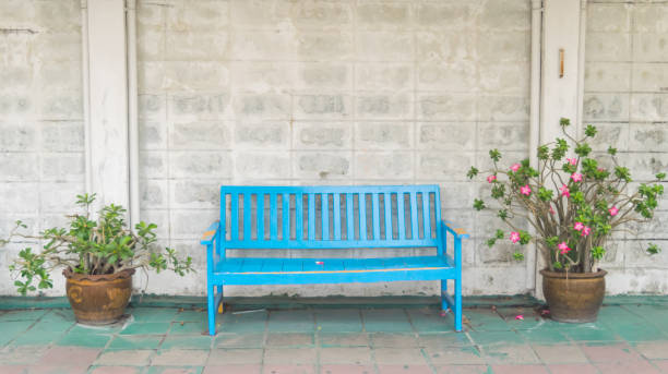 istock Brick wall, wooden window doors and chairs background 667285050