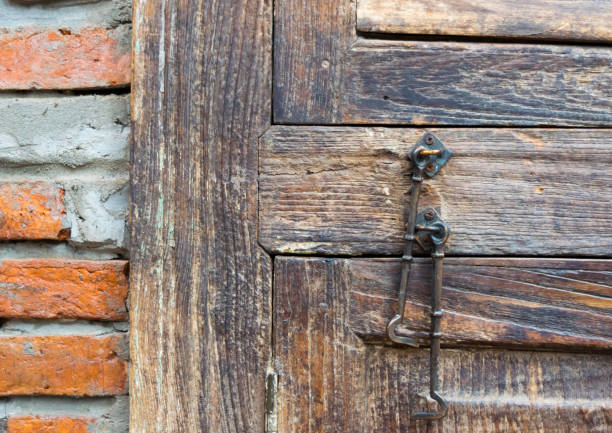 istock Brick wall, wooden window doors and chairs background 667285158