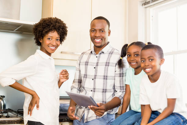 istock Happy family looking at tablet 667288126