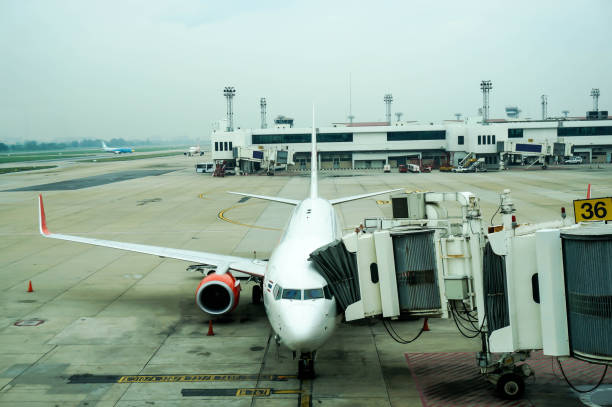 Passenger plane on the airfield ready for boarding at Don Mueang International Airport.
