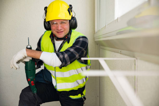 istock Male construction worker in hard hat drilling 667288680