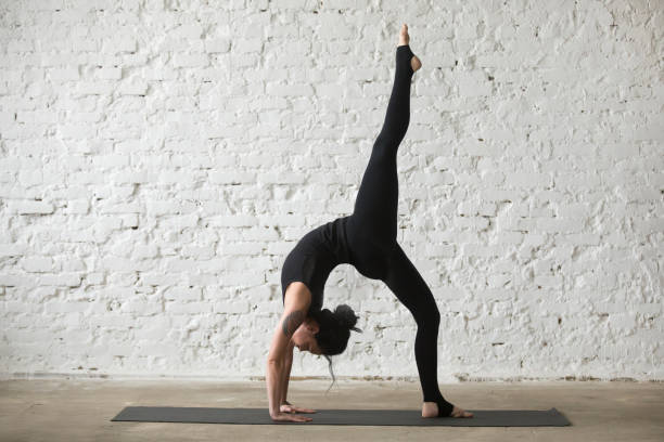 istock Young yogi attractive woman in Bridge pose, white loft background 667293842