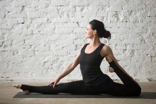 istock Young yogi attractive woman in Monkey God pose, loft background 667293864