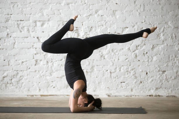 istock Young yogi attractive woman doing supported headstand pose variation 667293868