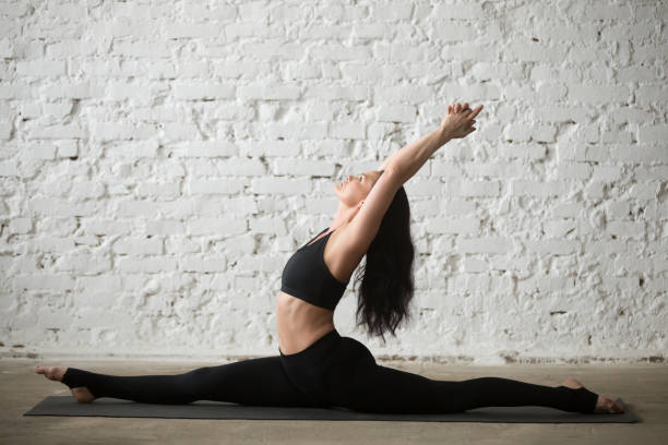 istock Young yogi attractive woman in Monkey God pose, white background 667293904