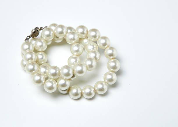 istock pearl necklace isolated on White clouds 667296862
