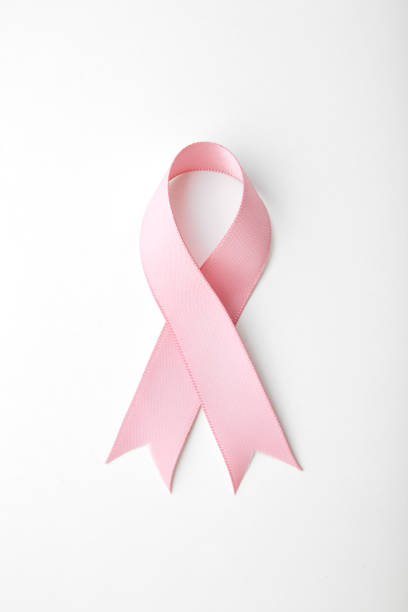 pink ribbon breast cancer - curled up ribbon isolated on white photography imagens e fotografias de stock