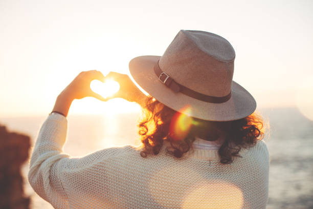 istock woman hipster making heart symbol with hands 667297464