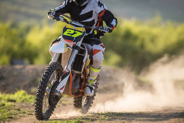 istock Unrecognizable man racing on motorcycle on dirt track. 667297856