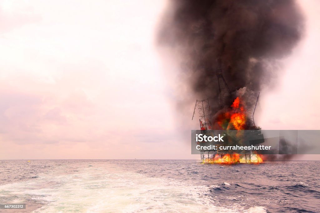 Offshore oil and rig construction damaged because worst case or fire case which can't control situation. Oil spill into the sea because incorrect of operation and accident in job out of safety rule. Offshore Platform Stock Photo