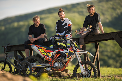 Three male extreme riders enjoying a day in nature and relaxing.