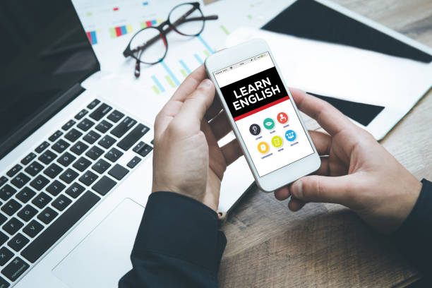 istock Hand holding smartphone and showing Learn English concept 667305220