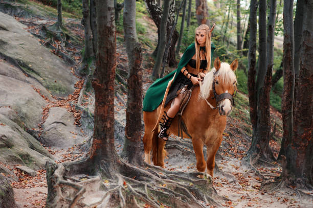 istock Female elf in the forest with her horse 667305308