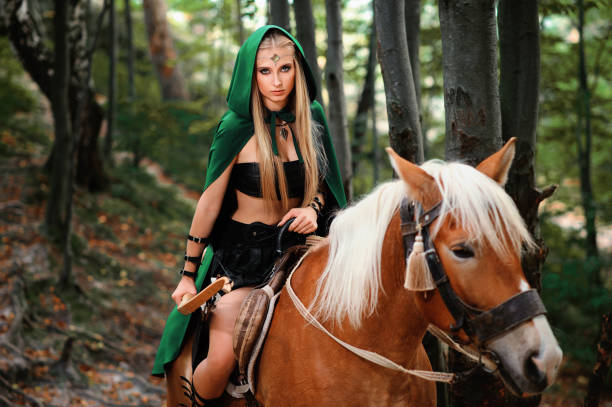 istock Female elf in the forest with her horse 667305330