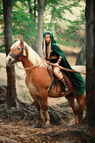 istock Female elf in the forest with her horse 667305388