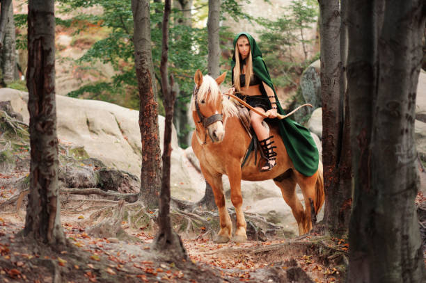 istock Female elf in the forest with her horse 667305410