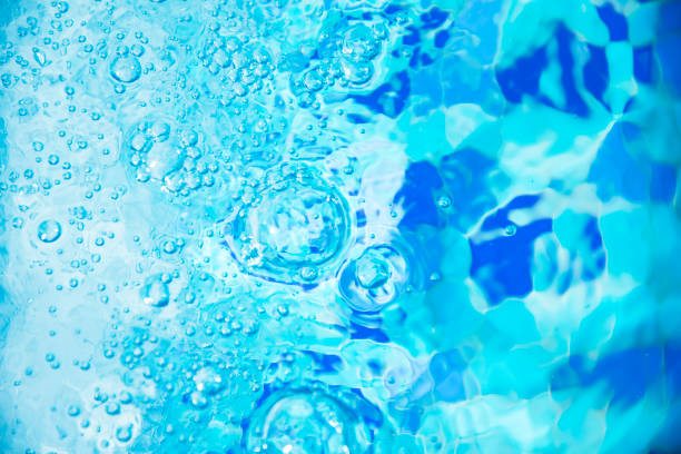 istock Air bubbles in clear blue water in pool for backgrounds. 667311928