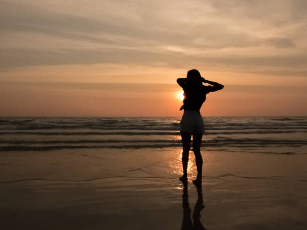 istock silhouette woman on the beach 667312714