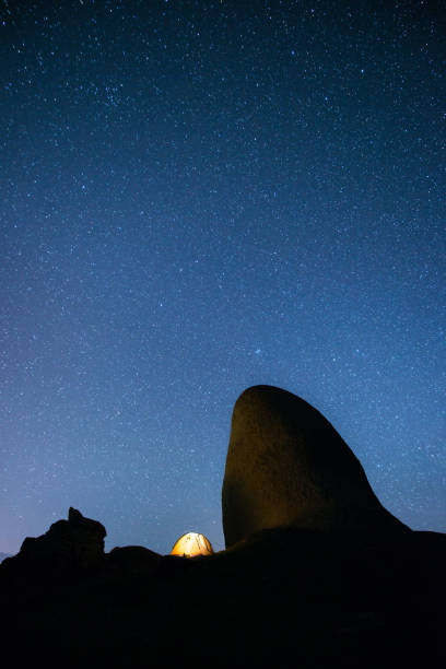 istock Glowing tent in the mountains under a starry sky 667312740