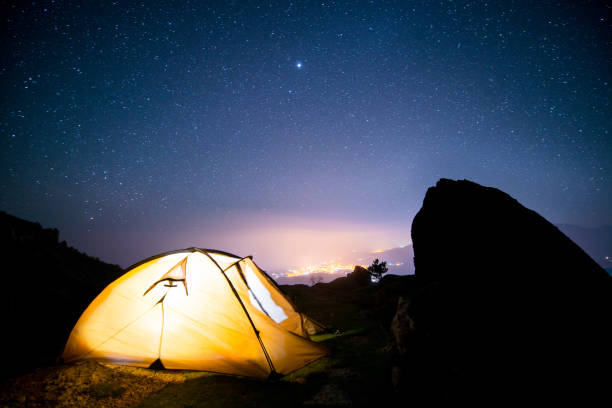istock Glowing tent in the mountains under a starry sky 667312750