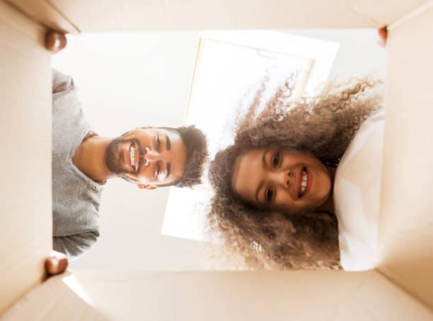 istock Man and a girl looking into a box 667312774