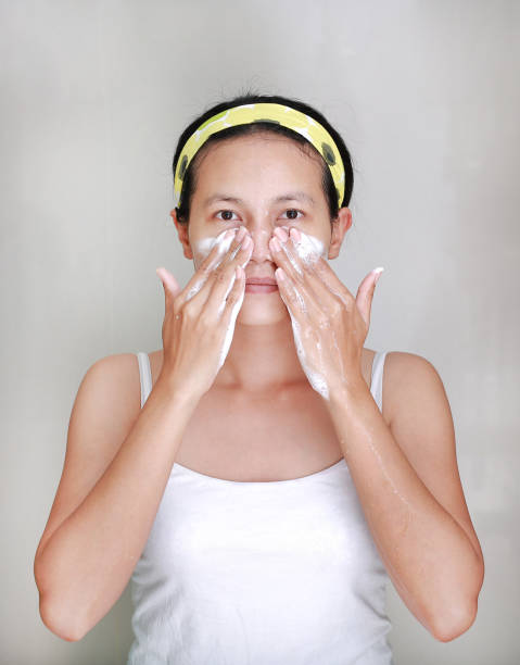 istock Woman applying foam cream to face 667312882