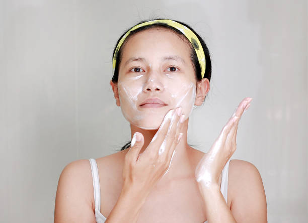 istock Woman applying foam cream to face 667315028