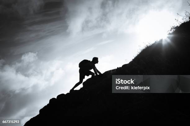 Man Climbing Up A Mountain Stock Photo - Download Image Now - Mountain, Moving Up, Clambering